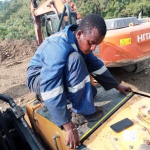 fuel monitoring installation team of walta technologies installing fuel sensor on excavator in weliso
